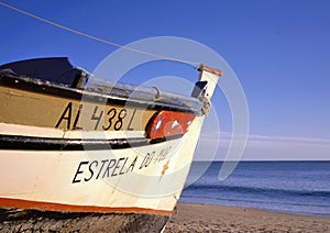 Colorful wooden Fishing Boat on the beach at sunset