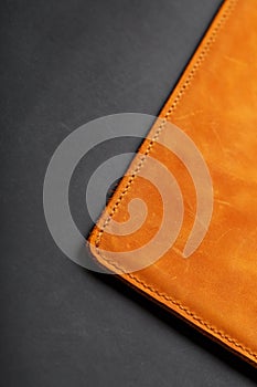 The album cover is made of brown genuine leather, handmade on a black background. Elements of a leather product close-up