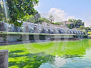 Alcalde Park's vibrant green waterway lined with stone pathways and fountains photo