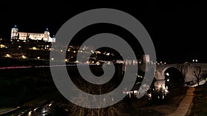 Alcantara Bridge, a historic construction located over the Tagus River and the Real Alcazar at night