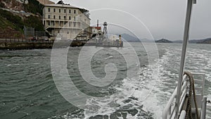 Alcatraz island in San Francisco Bay, California USA. Federal prison for gangsters on rock, foggy weather. Historic jail, cliff in