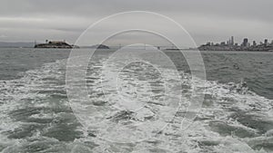 Alcatraz island in San Francisco Bay, California USA. Federal prison for gangsters on rock, foggy weather. Historic jail, cliff in