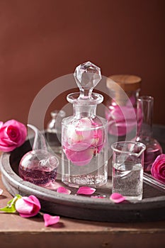 Alchemy aromatherapy with rose flowers flasks