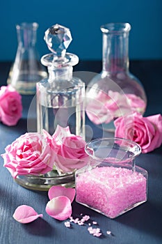 alchemy and aromatherapy set with rose flowers and chemical flasks