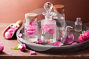 Alchemy and aromatherapy set with rose flowers and flasks