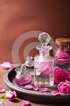 Alchemy and aromatherapy set with rose flowers and flasks