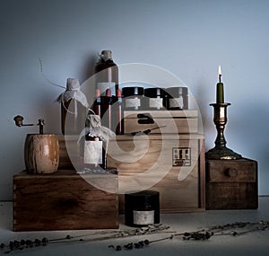 Alchemy lab. bottles, jars, candle on wooden shelves