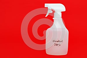 Alcohol 70% spray for protection against Coronavirus COVID-19 and other contagious diseases. Isolated on red background