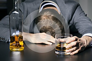 Alcohol addiction - drunk businessman holding a glass of whiskey