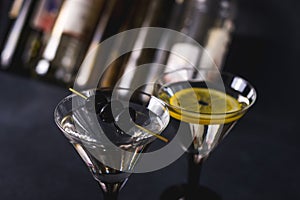 Alcohol cocktail with splash.Dry martini with black olives.Vermouth cocktail inside martini glass over dark background.Martini gla