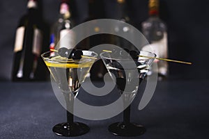 Alcohol cocktail with splash.Dry martini with black olives.Vermouth cocktail inside martini glass over dark background.Martini gla