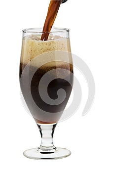 Alcohol dark beer with froth pouring into a glass photo