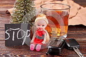 Alcohol beside doll and keys. photo