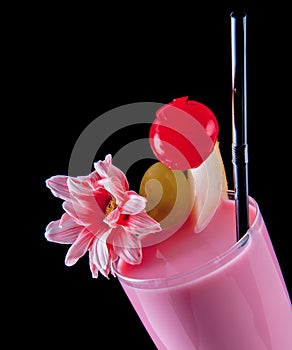 Alcohol drink, pink cocktail with flowers, strows, isolated black