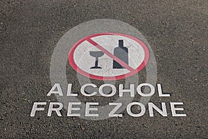 Alcohol free zone sign on pavement