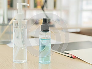 The alcohol gel with alcohol spray bottles is on the desk in the home office
