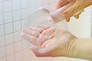 Alcohol gel in the hands, white gel tubes, squeeze the gel onto the hands, bright light, disinfection,