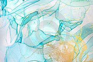 Alcohol ink blue and green abstract background with golden glitter. Ocean style watercolor texture.