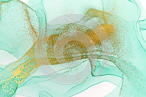 Alcohol ink green and gold abstract background. Drops watercolor texture.