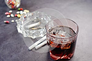 alcohol, pills and cigarette on table