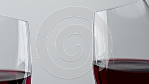 Alcohol red drink clinking wineglasses closeup. Cheering rose wine clear glasses