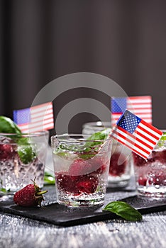 Alcohol shots of berries cocktail with a raspberry