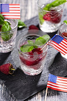 Alcohol shots of berries cocktail with a raspberry