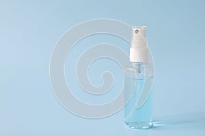 Alcohol spray in a bottle on blue background for clean hand and protect coronavirus or covid-19