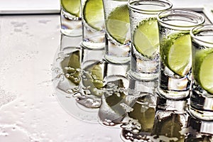 Alcohol. Tequila shot, lime, sea salt, ice, cocktail, party, close up, top view, copy space