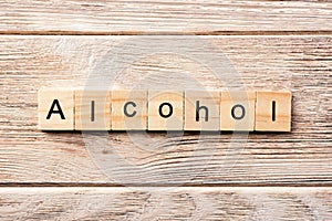 Alcohol word written on wood block. alcohol text on table, concept
