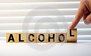 alcohol word written on wood block. alcohol text on table, concept