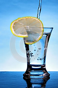 Alcoholic beverage with lemon slice