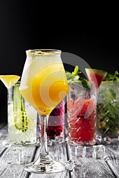 Alcoholic beverages and cocktails in elegant glasses on a dark background.