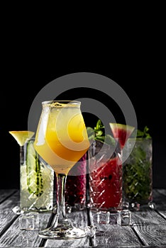 Alcoholic beverages and cocktails in elegant glasses on a dark background.