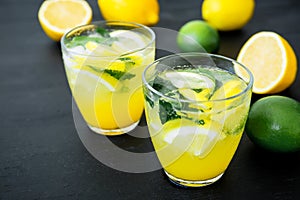 Alcoholic citrus lemonade with ice, lime and lemon in glass