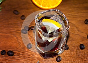 alcoholic cocktail in cristal glass with lemon slices and coffee beans