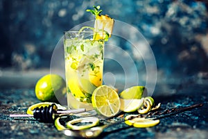 Alcoholic cocktail drink at bar or pub. Gin and lime cocktail with pineapple and ice served cold by bartender