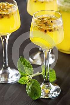 Alcoholic cocktail with fresh passion fruit with mint and ice. D