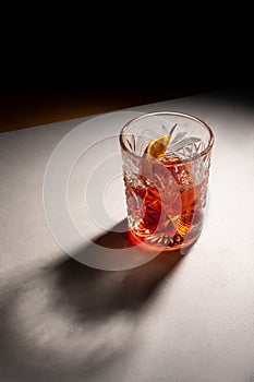 alcoholic cocktail with lemon in a glass crystal glass shadow