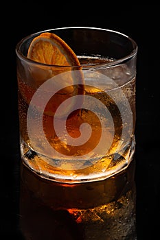 Alcoholic cocktail Old fashioned cocktail with orange slice and lump sugar