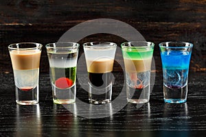 Alcoholic cocktail row on bar table, colorful party drinks