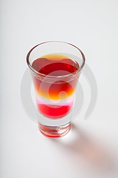 Alcoholic cocktail in shot glass isolated on white