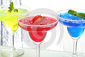 Alcoholic cocktails on silver background