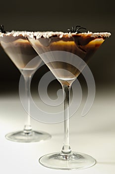 Alcoholic drink based on vodka and coffee liqueur served in a cocktail glass, decorated with chocolate, desiccated coconut and