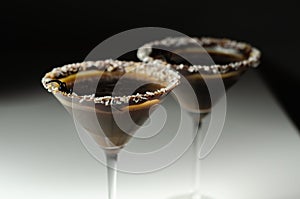 Alcoholic drink based on vodka and coffee liqueur served in a cocktail glass, decorated with chocolate, desiccated coconut and