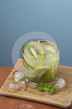 Alcoholic drink caipirinha based on kiwi and aguardente distilled cocktail drink and fruits photo