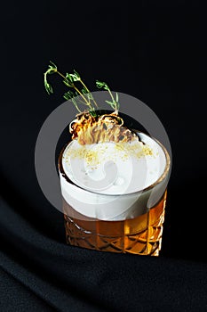 Alcoholic drink. A cocktail with elite alcohol on dark black background