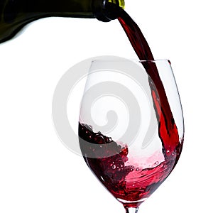 Alcoholic drink. Pouring expensive red wine from bottle into the