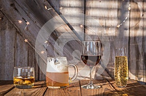 Alcoholic drinks on old weathered wood background