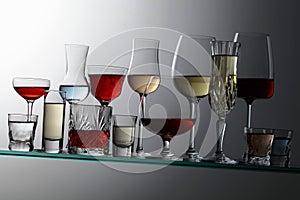 Alcoholic drinks on a tilted glass shelf